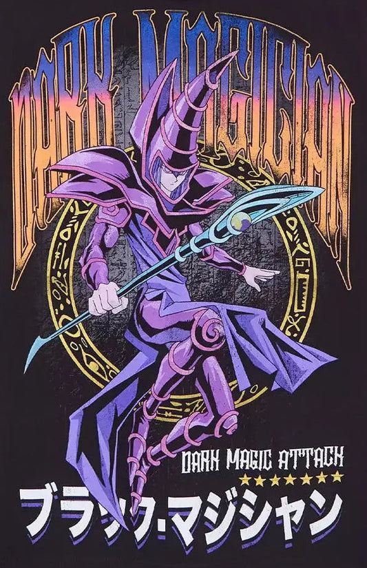 A black short-sleeve graphic t-shirt hanging on a wooden hanger against a light gray background. The shirt features a large front print of the Yu-Gi-Oh! character Dark Magic Attack, with purple, orange, and blue details, and Japanese text at the bottom.
