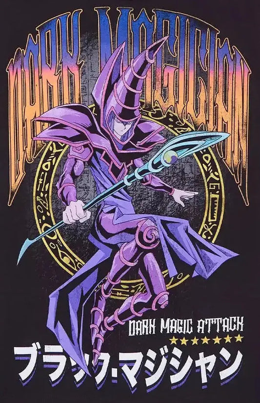 A black short-sleeve graphic t-shirt hanging on a wooden hanger against a light gray background. The shirt features a large front print of the Yu-Gi-Oh! character Dark Magic Attack, with purple, orange, and blue details, and Japanese text at the bottom.