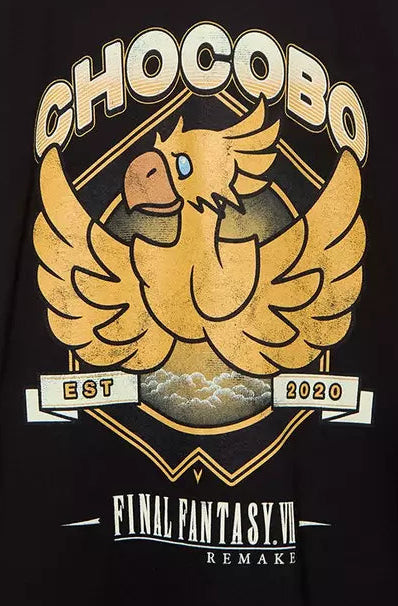 A black short-sleeve graphic T-shirt hanging on a wooden hanger against a light gray background. The shirt features a large gold and beige chakra-style bird graphic with the text 'CHOCOBO' and 'Final fantasy' on the front.