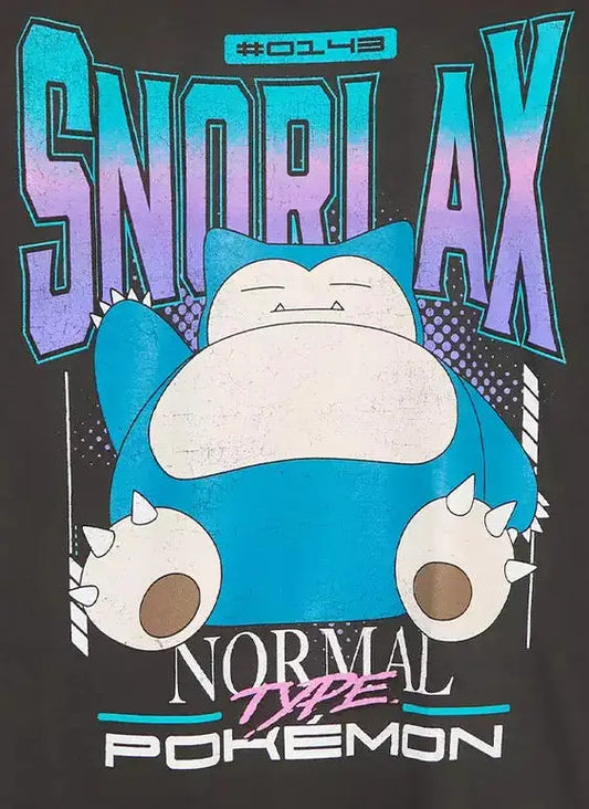 A black short-sleeve graphic T-shirt hanging on a wooden hanger against a light gray background. The shirt features a large front print with the word 'SNORLAX' in blue and purple, a blue and white Snorlax character, and the text 'NORMAL Type POKEMON' below.