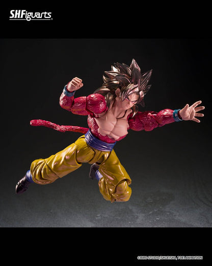 SH Figuarts Super Saiyan 4 goku action figure from Dragon Ball gt, standing in a dynamic pose with arms crossed over his chest. The figure features his signature metallic gold gi pants, a blue waistband, a pink Super Saiyan hairpiece, and a long pink tail, set against a dark studio background.