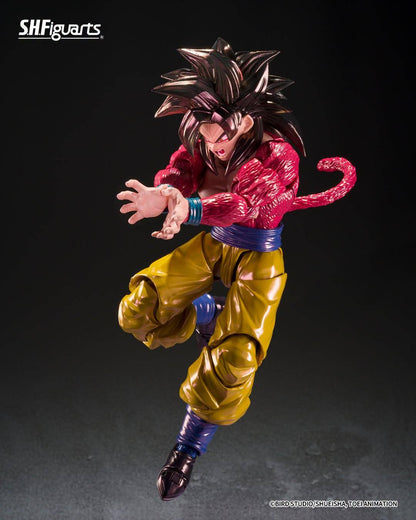 SH Figuarts Super Saiyan 4 goku action figure from Dragon Ball gt, standing in a dynamic pose with arms crossed over his chest. The figure features his signature metallic gold gi pants, a blue waistband, a pink Super Saiyan hairpiece, and a long pink tail, set against a dark studio background.