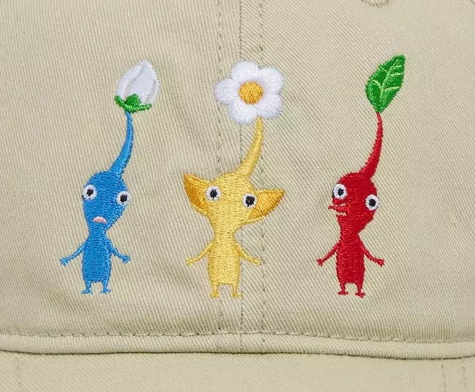 A beige baseball cap featuring embroidered Pikmin characters on the front panel, set against a plain white background.