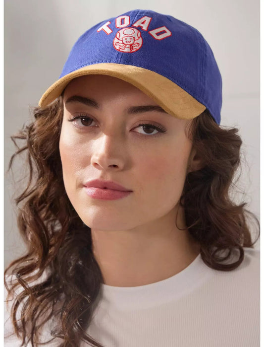 Person wearing a blue and yellow cap with Blue and brown cap with Nintendo Super Mario Bros. Toad logo on a white background