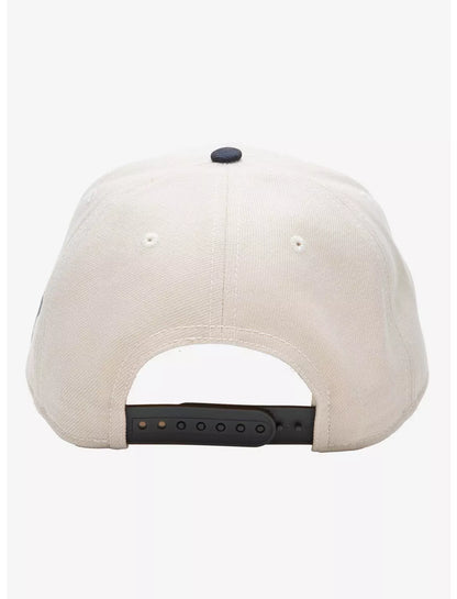 A structured baseball cap with a cream-colored crown, dark gray brim, and black embroidered Pokemon umbreon Japanese characters over large white and black  numerals on the front.