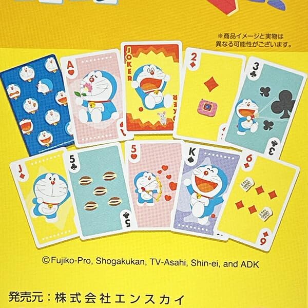A set of Doraemon-themed playing cards displayed on a bright yellow background. The cards feature various suits and face values decorated with illustrations of Doraemon, his cat Neemo, and iconic scenes from his stories.