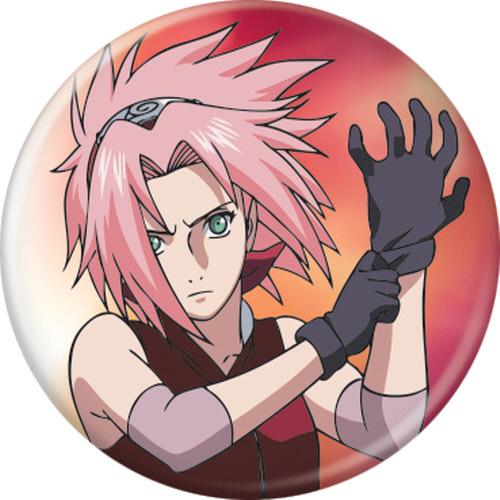 Round pin-back button badge featuring an anime illustration of Sakura Haruno from Naruto, with pink hair, green eyes, black gloves, and a red-orange gradient background.