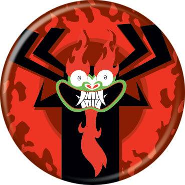 A circular button featuring Samurai Jack Aku illustration of a fiery red demon face with black spider-like arms and a green mouth, set against a red and black patterned background.