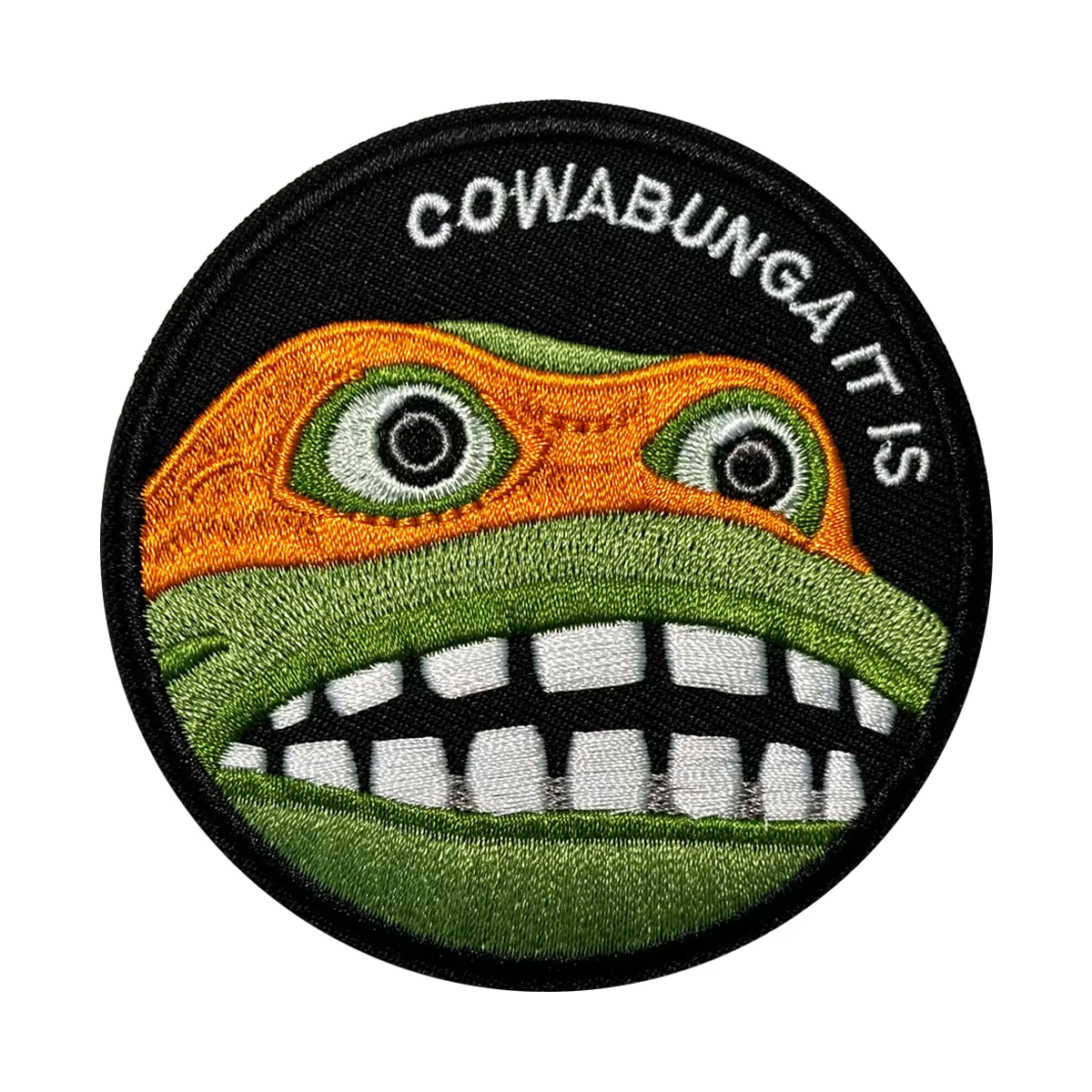 Circular patch of Teenage Mutant Ninja Turtles TMNT Michelangelo with a cartoonish face and 'Cowabunga It Is' text on a white background