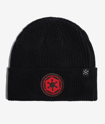A black Star wars ribbed knit beanie hat featuring a red and black circular Star Wars Galactic Empire crest patch on the front cuff, with a small white embroidered logo on the side, shown against a light gray background.