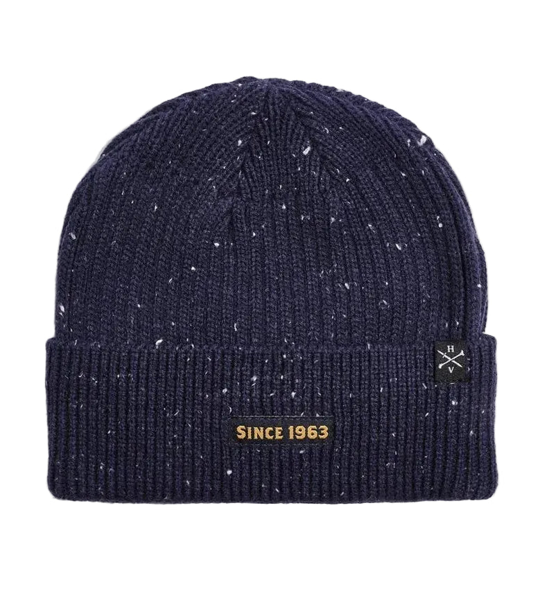 A navy blue knit x-men beanie with white speckles, featuring a black embroidered patch on the front cuff that reads 'XAVIER INSTITUTE' with a gold cross logo.