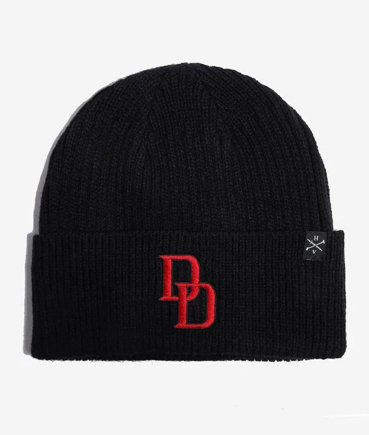A black ribbed knit Marvel Daredevil beanie hat featuring a red embroidered 'DD' logo on the front cuff and a small black square brand tag on the right side, set against a plain white background.