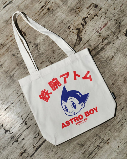 Tote bag with Astro Boy design on a wooden surface