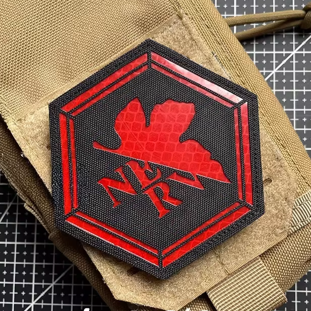 Hexagonal Evangelion NERV logo Reflective Hook & Loop Patch with red 'NERV' logo on a black background