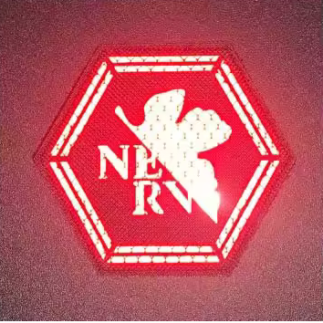 Hexagonal Evangelion NERV logo Reflective Hook & Loop Patch with red 'NERV' logo on a black background