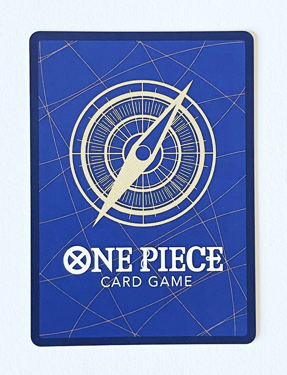 Blue card game packaging with a compass design and 'One Piece' branding.