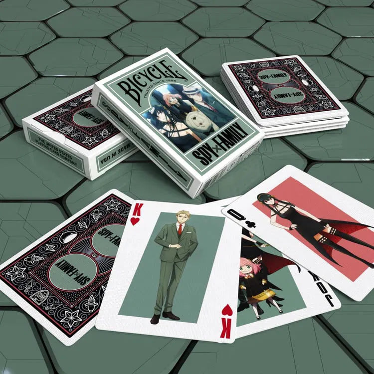 Bicycle Spy Family playing cards on a green tiled surface