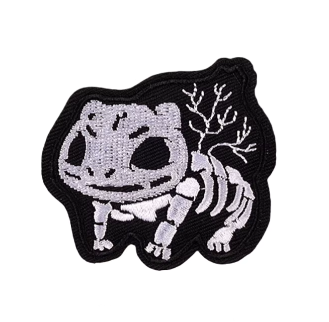 Embroidered patch of a skeleton pokemon Bulbasaur on a white background