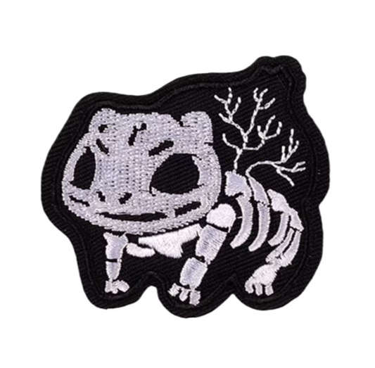 Embroidered patch of a skeleton pokemon Bulbasaur on a white background