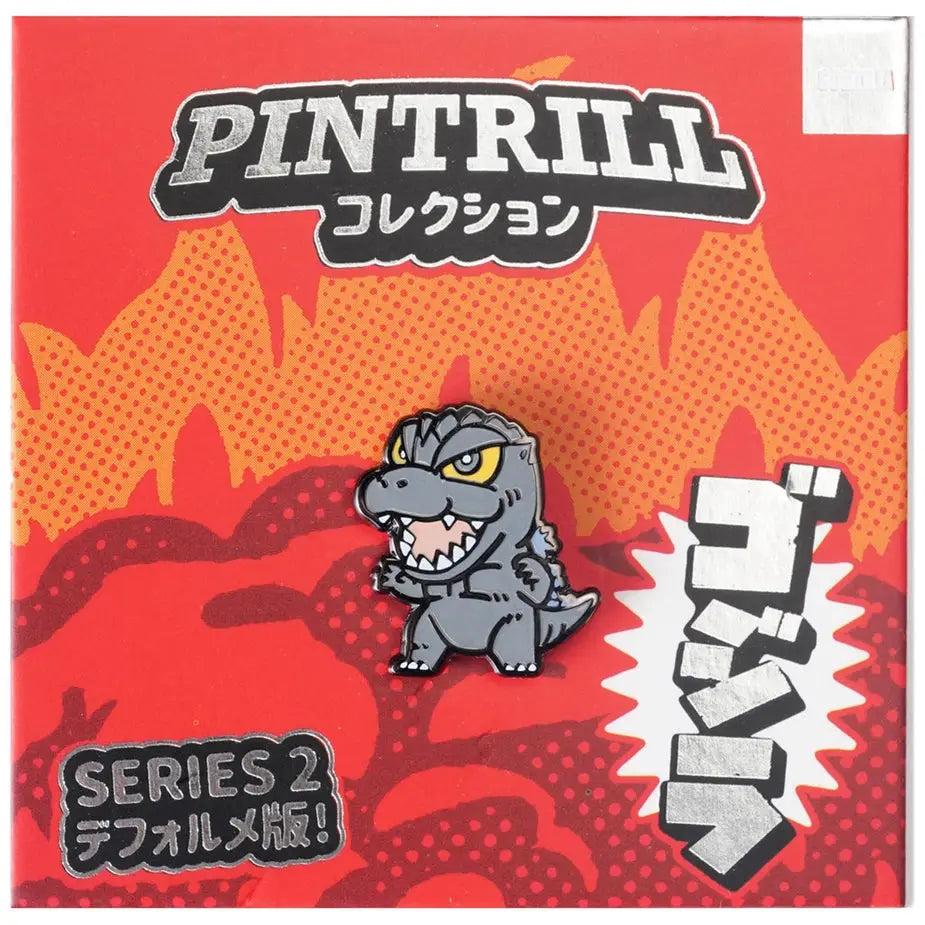 A collectible enamel pin of a cartoonish gray monster, styled like Godzilla, on its original red and orange Japanese packaging card by Pintrill Collection.