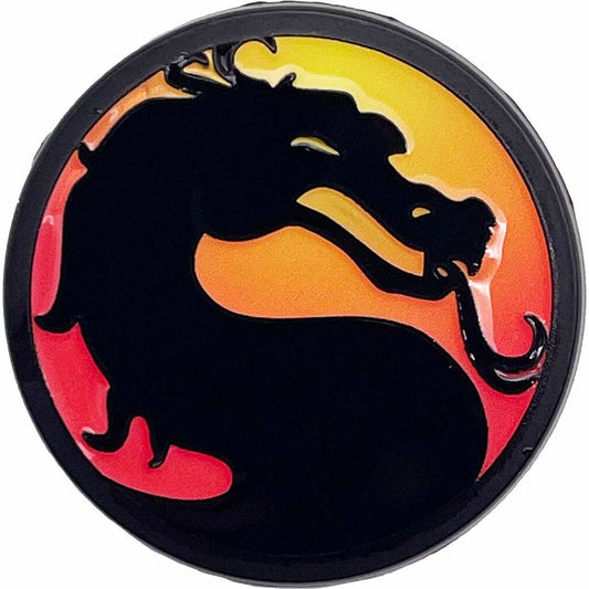 A circular emblem featuring the black Mortal Kombat dragon silhouette against a vibrant yellow-to-red gradient background.