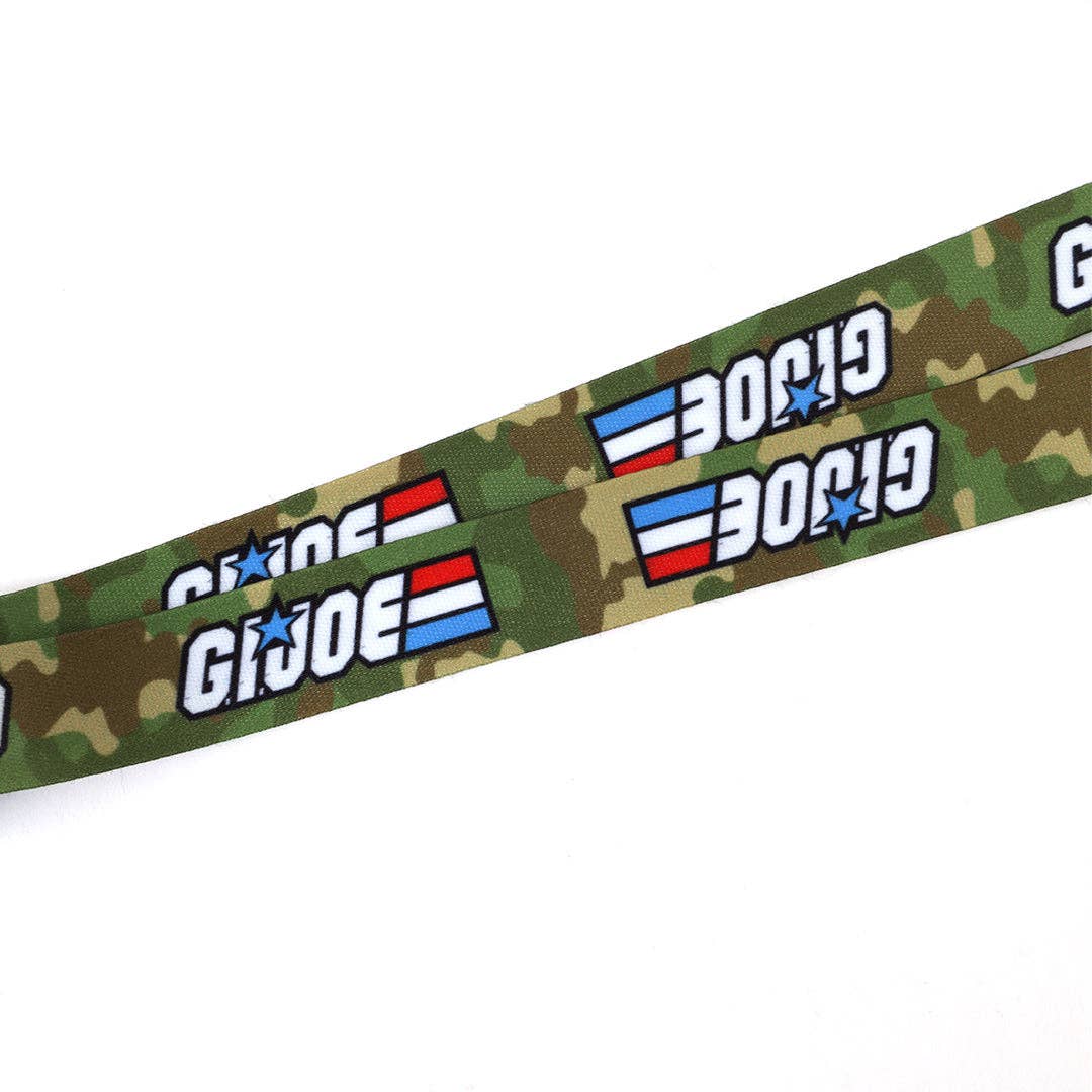 Officially licensed G.I. Joe lanyard featuring two collectible metal charms, a durable 20" polyester strap, and classic 1980s-inspired designs for fans and collectors.