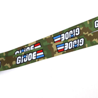 Officially licensed G.I. Joe lanyard featuring two collectible metal charms, a durable 20" polyester strap, and classic 1980s-inspired designs for fans and collectors.