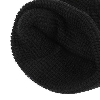 Close-up of a black knit beanie on a white background