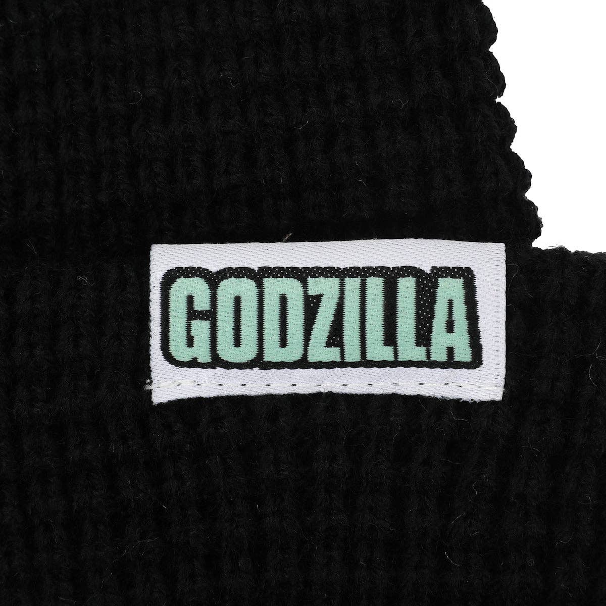Close-up of black shoelace with 'GODZILLA' label on a white background