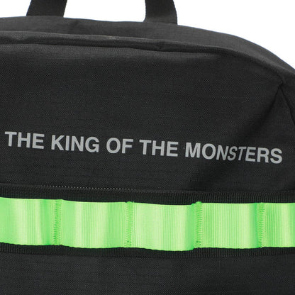 Black bag with 'The King of the Monsters' text and green stripe on a white background