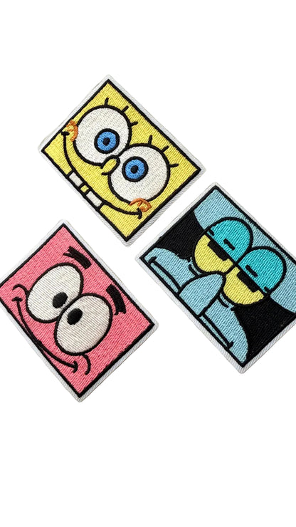Three cartoon character patches featurinng spongebob squarepants, patrick star and squidward, on a white background