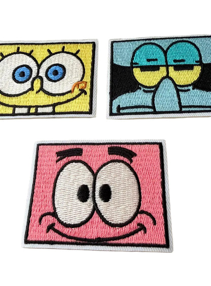 Three cartoon character patches featurinng spongebob squarepants, patrick star and squidward, on a white background