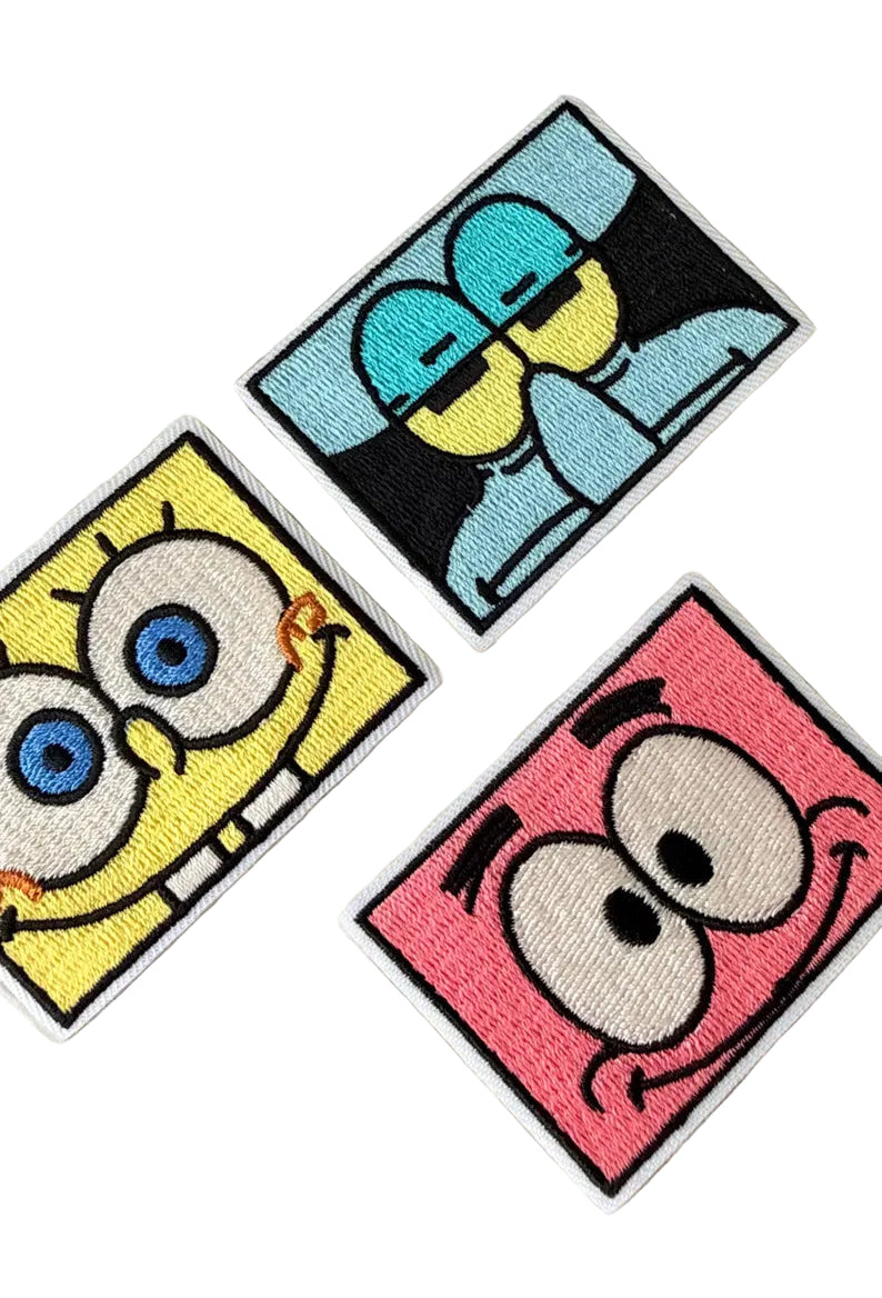 Three cartoon character patches featurinng spongebob squarepants, patrick star and squidward, on a white background