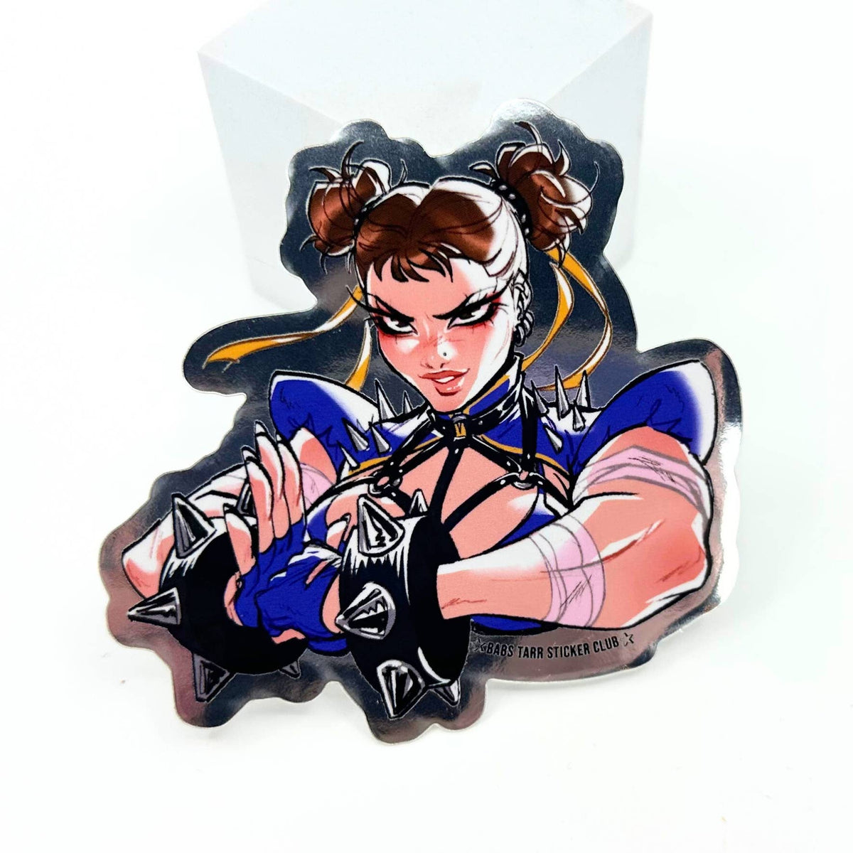 A die-cut vinyl sticker or decal of the anime character Chun-Li in her signature blue and gold jumpsuit