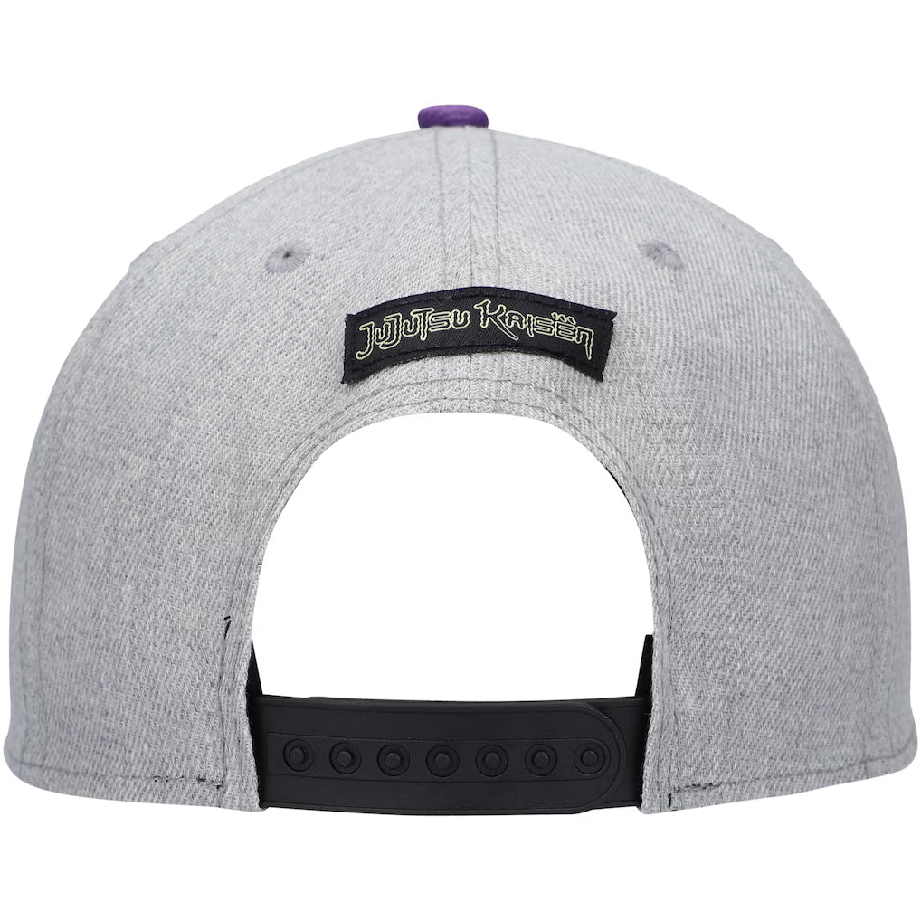The back of a heather gray snapback cap featuring a black patch with the text 'jujutsu kaisen' in white and black, a black adjustable strap, and a small purple button on top.