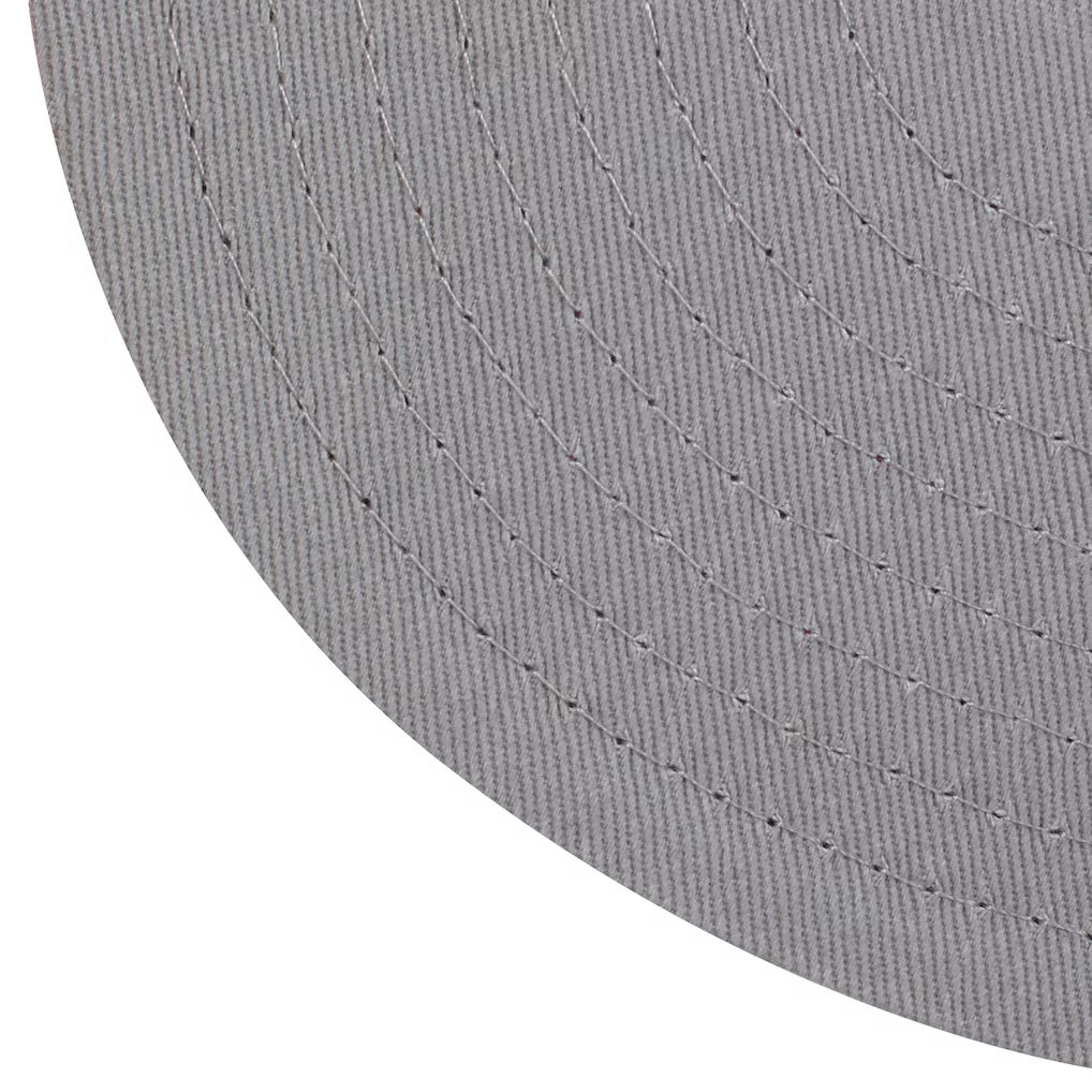 Close-up of a textured gray fabric surface with visible stitching