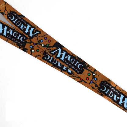 A Magic: The Gathering collectible belt or strap featuring the iconic brown wood texture, black splatters, and blue logo text, shown diagonally on a white background.
