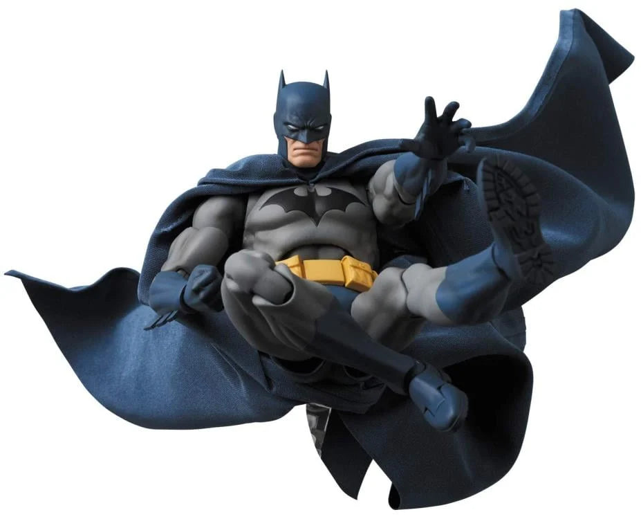 Batman figurine holding a gun on a white background