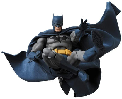 Batman figurine holding a gun on a white background