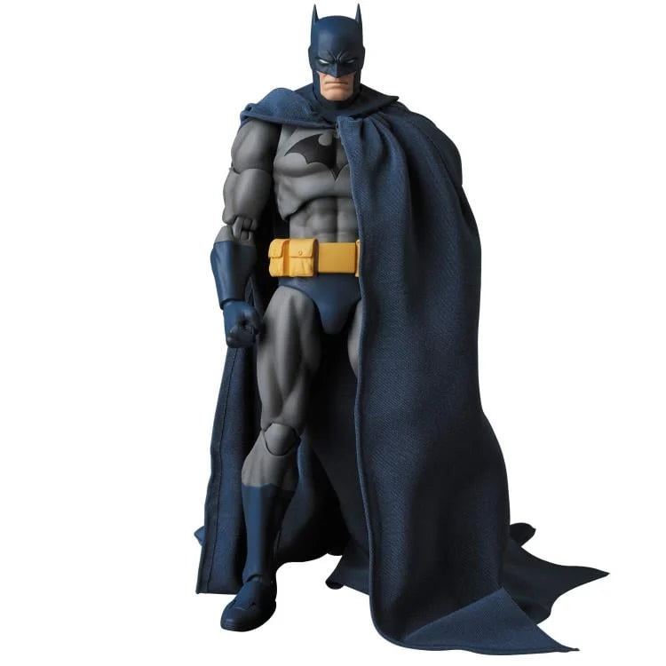 Batman action figure with cape and mask on a white background
