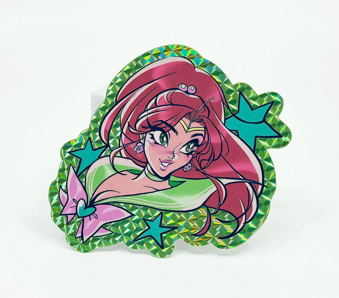 A die-cut acrylic pin featuring an anime-style character with pink hair, a green top, and blue star accents, set against a plain white background.