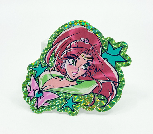 A die-cut acrylic pin featuring an anime-style character with pink hair, a green top, and blue star accents, set against a plain white background.