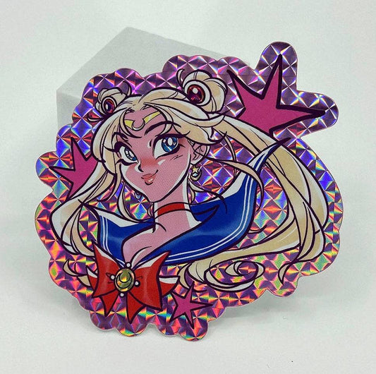 A Sailor Moon holographic sticker with a pink and purple iridescent border, shown on a white background.